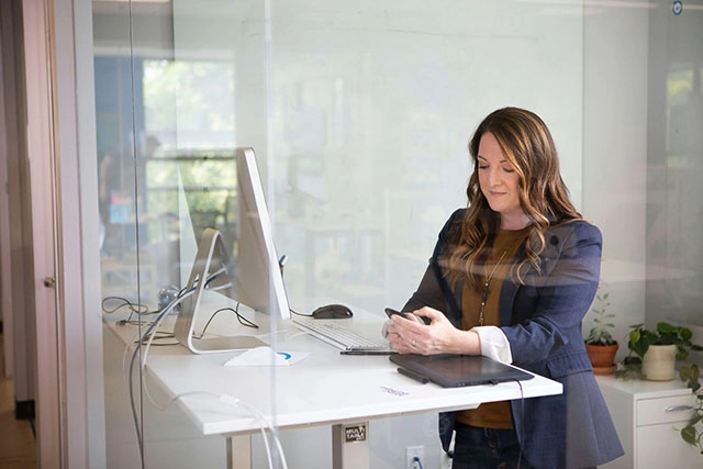 a sales solution lady in her white table holding her phone
